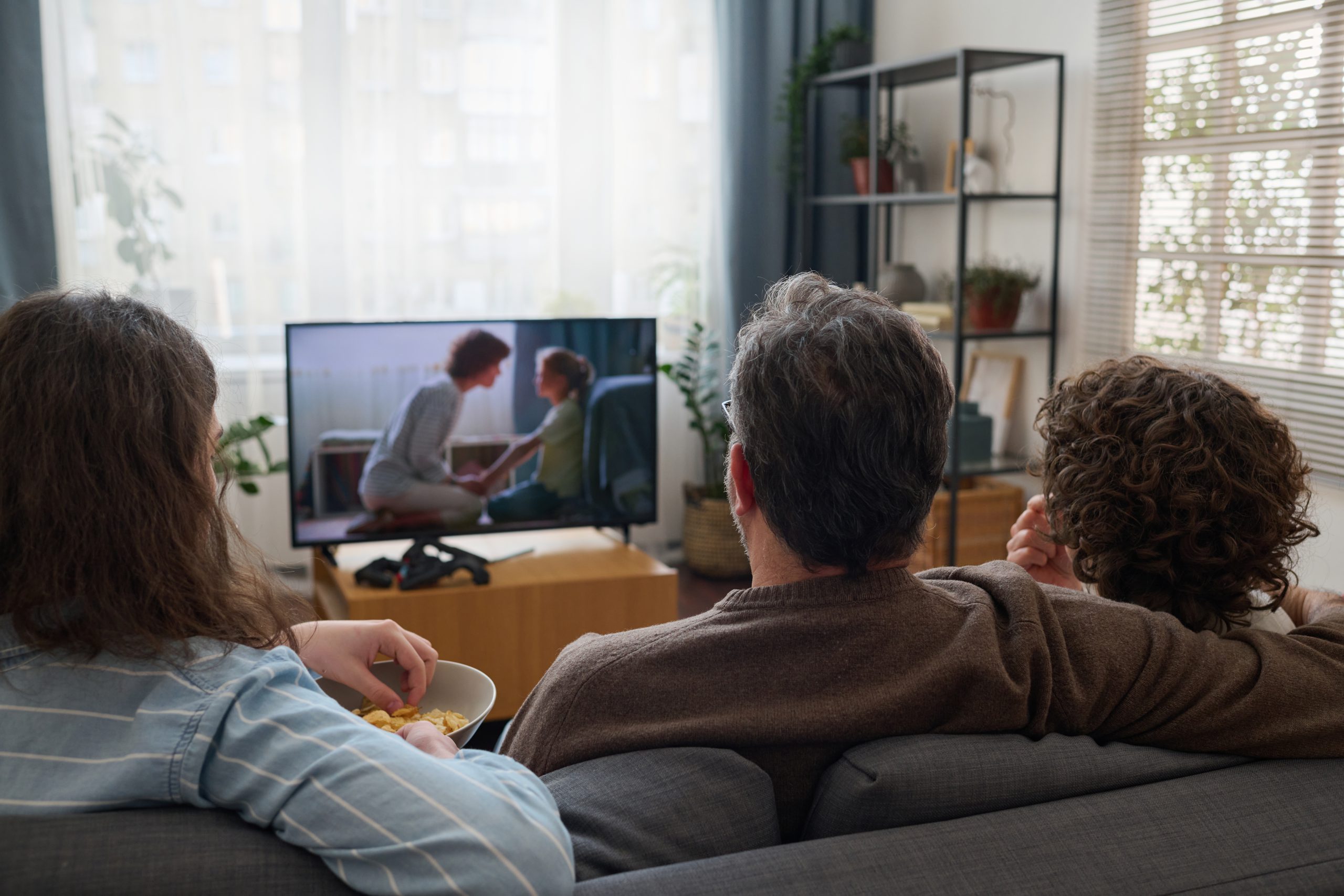 Family watching TV together in the living room